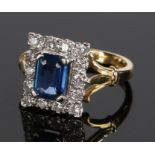 18 carat gold sapphire and diamond set ring, the central baguette sapphire with a diamond