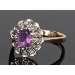 9 carat gold amethyst and diamond set ring, with an oval amethyst and diamond surround, ring size L