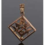 Yellow metal Masonic pendant, with tools between a square frame, 25mm diameter, 4.3 grams