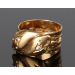 18 carat gold and diamond set double headed snake ring, the snake heads each set with a single