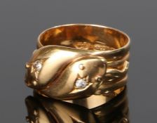 18 carat gold and diamond set double headed snake ring, the snake heads each set with a single