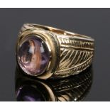 9 carat gold amethyst ring, the oval amethyst flanked by pierced and line decorated shoulders,