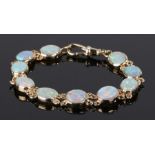 9 carat gold braclet with ten oval opal panels, 12g