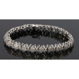 18 carat white gold diamond set bracelet, with X links between diamond clusters, 13.4 grams, 19cm