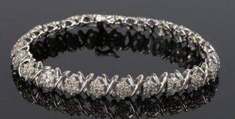 18 carat white gold diamond set bracelet, with X links between diamond clusters, 13.4 grams, 19cm