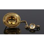 Victorian citrine set brooch, the oval citrine set into a yellow metal mount, 25mm diameter