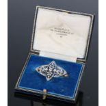 Early 20th Century diamond set brooch, with a petal design on white metal, 33mm diameter