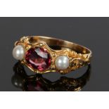 19th Century garnet and pearl set ring, the central oval garnet with a pearl to either side, ring