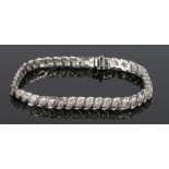 9 carat white gold diamond set bracelet, with a row of diamonds set to the wavy link bracelet, 13.