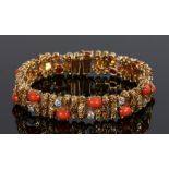 Gold diamond and coral bracelet, with coral and diamond set between bark effect links, 16cm long, 41