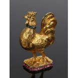 An impressive gold, diamond, emerald and ruby scent bottle in the form of a rooster. with diamond
