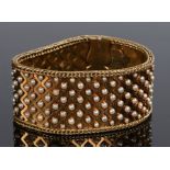 Impressive Edwardian gold and pearl bracelet, of large proportions a waved link effect set with