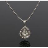 Diamond pendant necklace, the pendant with a central pear cut diamond and diamond surround, with