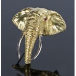 18 carat gold elephant head brooch, set with ruby eyes with a arched trunk and long white gold