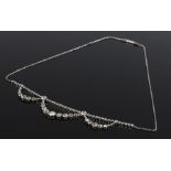 Diamond set necklace, with a row of diamonds to the front of the chain and three diamond set