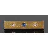 French 18 carat gold sapphire and diamond set brooch, with a central sapphire flanked by a diamond