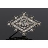 Diamond set brooch, with a central round cut diamond with a petal and smaller round cut diamond