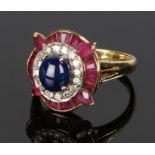 18 carat gold sapphire ruby and diamond set ring, the cabochon sapphire above a surround of diamonds
