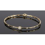 Ippolita 18 carat gold and diamond set bracelet, with two larger and sixteen smaller diamonds to the