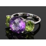 14 carat white gold amethyst and peridot ring, the central amethyst flanked by two peridot, ring