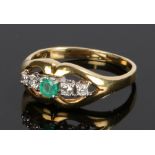 18 carat gold emerald and diamond set ring, with a central emerald flanked by two diamonds to