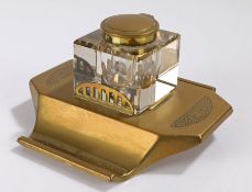 Art Deco brass and glass inkwell, the hinged brass lid above a clear glass body and brass base