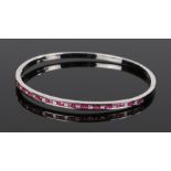 18 carat gold ruby and diamond bangle, set with square cut rubies and diamonds, 66mm diameter, 14.