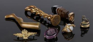 Collection of objects, to include two seals, a banded agate pendant, a snake sphere, a badge a