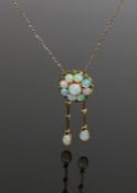 Opal set necklace, with a flower head design set with opals above opal drops with emerald set to the