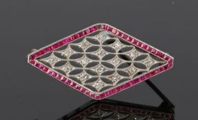 Art Deco diamond and ruby brooch, the fret diamond set brooch with a ruby surround set to white