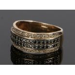 9 carat gold black and white diamond set ring, with rows to the wide head, ring size P