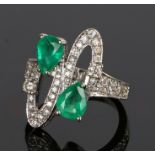 18 carat white gold diamond and emerald set ring with two pear cut emeralds and arched loop