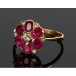 Diamond and ruby set ring, in the form of a flower head set with a central diamond and ruby