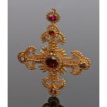 Gilt metal cross, set with garnet coloured stones to the bead and flame cross, 54mm diameter