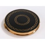 Stratton gilt metal compact, the lid with gilt wavy line decoration on a black ground, the