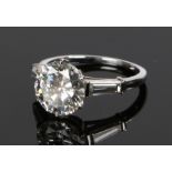 Van Cleef & Arpels, a stunning diamond set ring, the central brilliant cut 3.03 carat diamond,