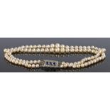 Pearl, Sapphire and diamond necklace, with a double row of graduated pearls attached to the sapphire