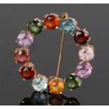 18 carat brooch, set with multiple stones to the surround, 33mm diameter