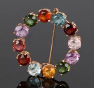 18 carat brooch, set with multiple stones to the surround, 33mm diameter
