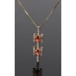 9 carat gold diamond and orange garnet pendant, in the form of conjoined crosses, with a 9 carat