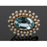 Aquamairne and pearl set brooch, with a central aquamarine at 5.60 carats and a pearl surround, 25mm