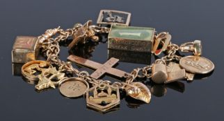 9 carat gold charm bracelet, with various charms to include a cross, a letter R, a carpet, a mosque,
