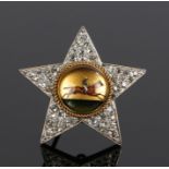 Essex crystal and diamond set brooch, with a central jockey and diamond set star edge, 32mm diameter