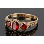 9 carat gold garnet set ring, with three garnets to the head, ring size N