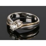 18 carat two colour gold and diamond ring, the central diamond flanked by two smaller diamonds, ring