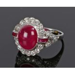 Platinum diamond and ruby set ring, the central cabochon ruby flanked by further rubies and a