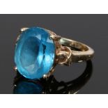 9 carat gold blue topaz ring, the oval topaz flanked by pierced shoulders, ring size O, 7g