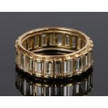 18 carat gold diamond set eternity ring, with a row of baguette cuts diamonds set to the shank, ring