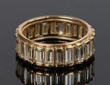 18 carat gold diamond set eternity ring, with a row of baguette cuts diamonds set to the shank, ring