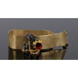 Silver and gilt metal bracelet, with a silver rampant lion holding a shield set with a garnet with a